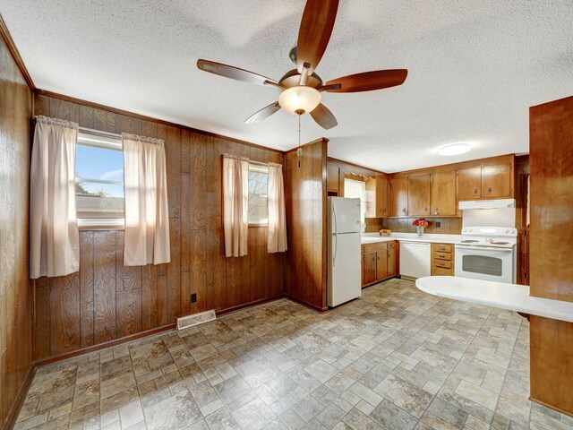440 Appleton Dr, Clarksville, TN 37042 - kitchen with light countertops, white appliances, wooden walls, visible vents, and a ceiling fan