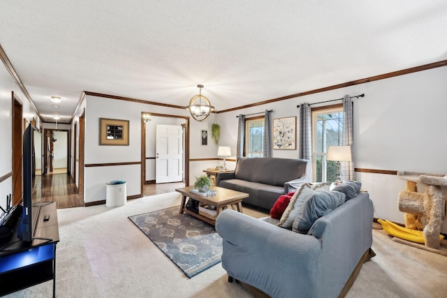 living room featuring crown molding, carpet flooring, an inviting chandelier, baseboards, and a textured ceiling