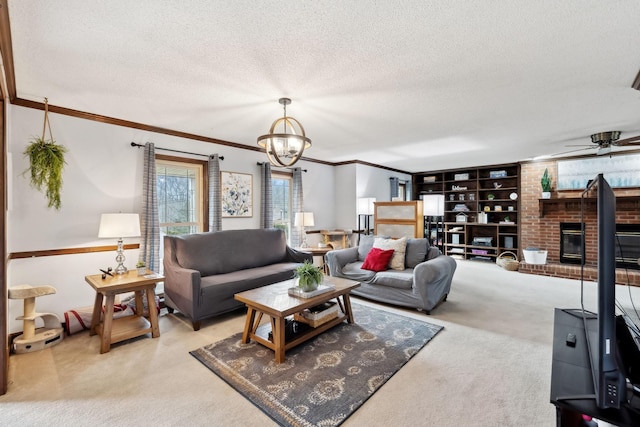 carpeted living room featuring a textured ceiling, crown molding, a brick fireplace, built in shelves, and ceiling fan with notable chandelier