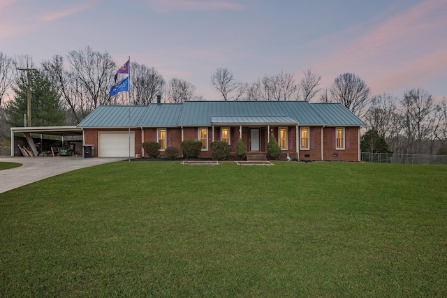 ranch-style house featuring concrete driveway, a carport, brick siding, a garage, and a lawn