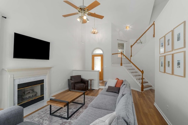 6525 Chessington Dr, Nashville, TN 37221 - living room with stairway, baseboards, a high ceiling, ceiling fan, and wood finished floors