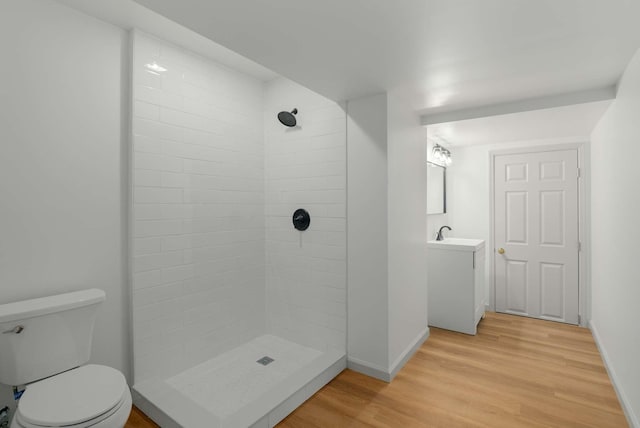 6525 Chessington Dr, Nashville, TN 37221 - full bathroom featuring vanity, toilet, baseboards, tiled shower, and wood finished floors
