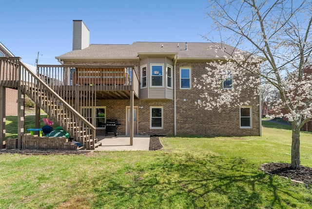6525 Chessington Dr, Nashville, TN 37221 - back of property with a patio area, stairway, a chimney, brick siding, and a lawn