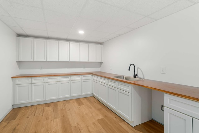 6525 Chessington Dr, Nashville, TN 37221 - kitchen featuring white cabinetry, light wood-style floors, and a sink