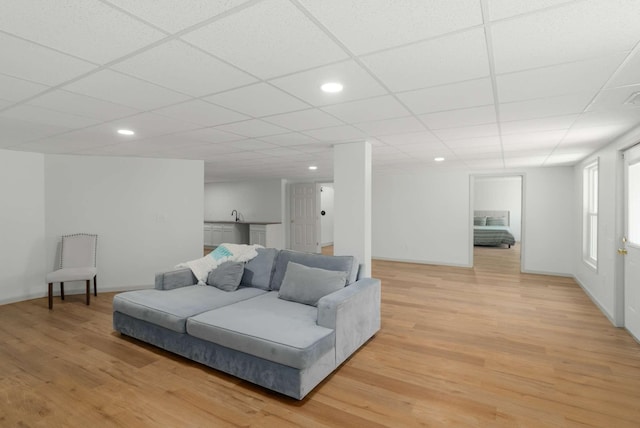 6525 Chessington Dr, Nashville, TN 37221 - living area featuring baseboards, a drop ceiling, and light wood-style floors