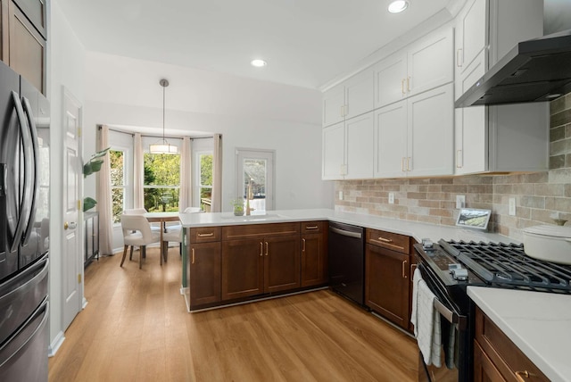 6525 Chessington Dr, Nashville, TN 37221 - kitchen featuring stainless steel fridge, gas stove, dishwasher, a peninsula, and ventilation hood