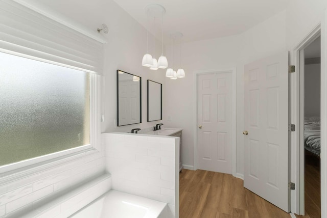 6525 Chessington Dr, Nashville, TN 37221 - bathroom with a bath, wood finished floors, a chandelier, and a sink