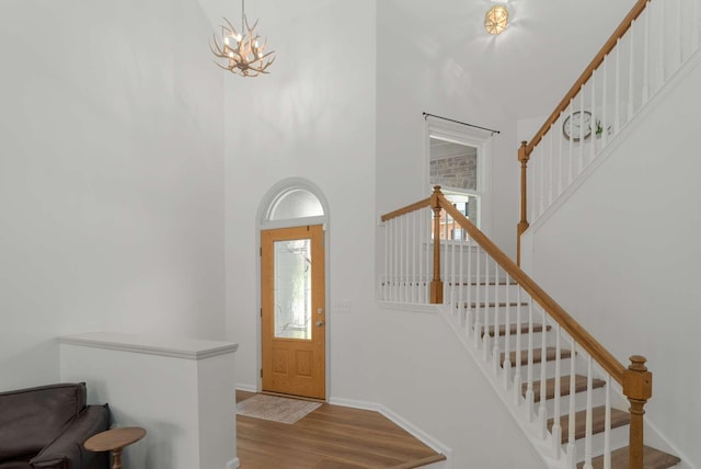 6525 Chessington Dr, Nashville, TN 37221 - foyer entrance with baseboards, wood finished floors, stairway, a high ceiling, and a notable chandelier
