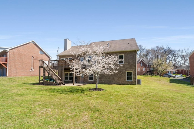6525 Chessington Dr, Nashville, TN 37221 - rear view of house with stairs, a chimney, a deck, brick siding, and a yard