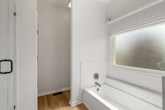 6525 Chessington Dr, Nashville, TN 37221 - full bath featuring a stall shower, a garden tub, wood finished floors, baseboards, and visible vents