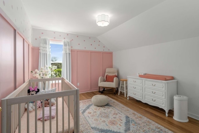 6525 Chessington Dr, Nashville, TN 37221 - bedroom with a nursery area, vaulted ceiling, and wood finished floors
