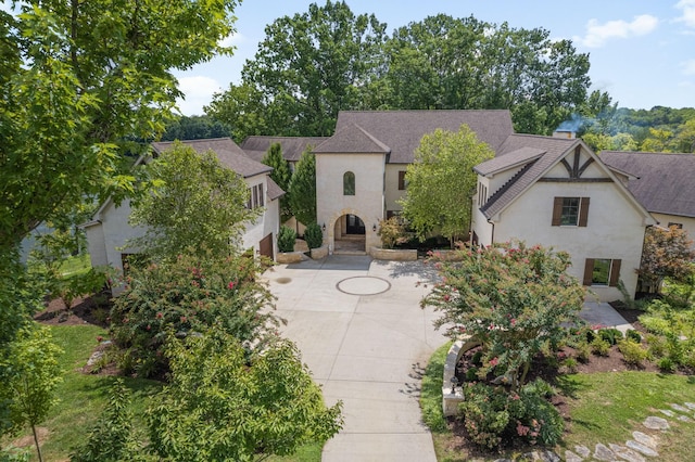 817 Burton Point Rd, Mount Juliet, TN 37122 - view of front of property featuring a patio, a garage, concrete driveway, stucco siding, and a shingled roof