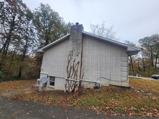 906 Edwards St, Madisonville, KY 42431 - view of home's exterior with a chimney and brick siding