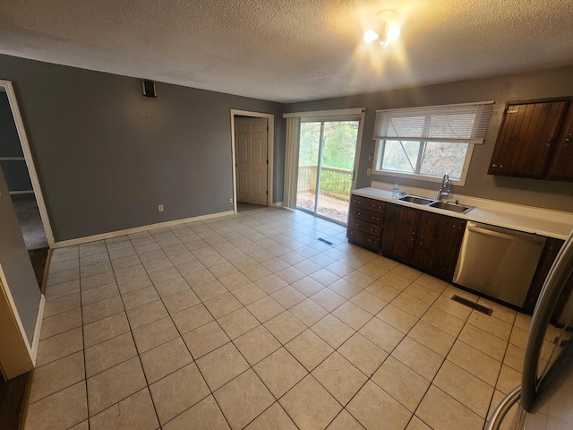 906 Edwards St, Madisonville, KY 42431 - kitchen featuring light countertops, dark brown cabinetry, a sink, dishwasher, and visible vents