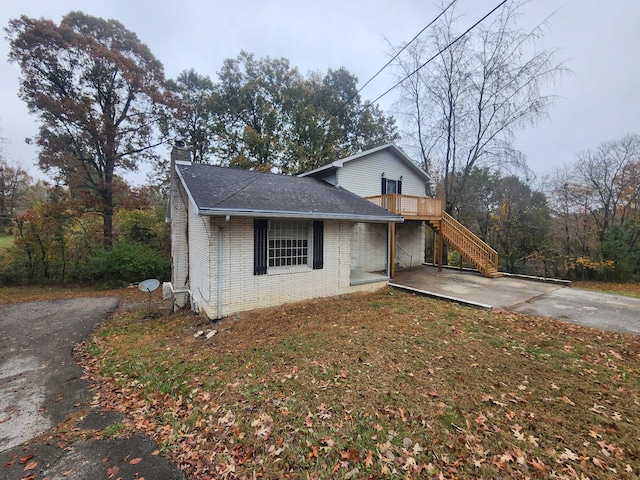 906 Edwards St, Madisonville, KY 42431 - view of front of home with a chimney, concrete driveway, stairway, brick siding, and roof with shingles