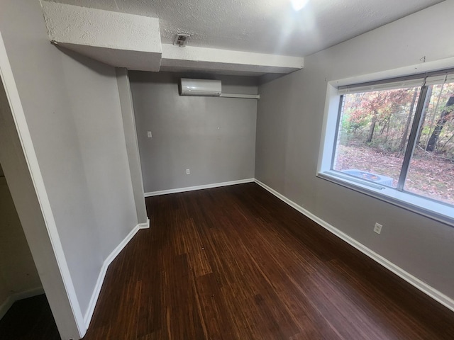 906 Edwards St, Madisonville, KY 42431 - below grade area featuring baseboards, a wall mounted AC, wood finished floors, and a textured ceiling