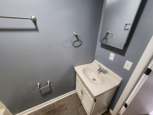 906 Edwards St, Madisonville, KY 42431 - bathroom with baseboards, stone finish floor, and vanity