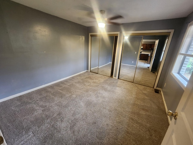 906 Edwards St, Madisonville, KY 42431 - unfurnished bedroom with baseboards, multiple closets, visible vents, and carpet