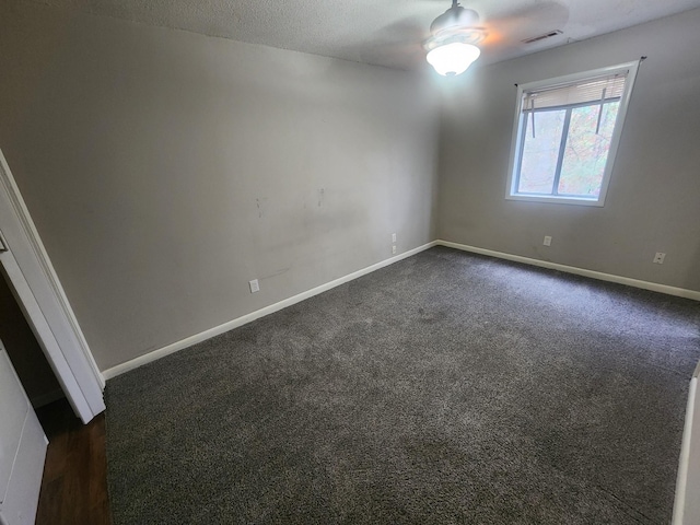 906 Edwards St, Madisonville, KY 42431 - unfurnished room featuring a ceiling fan, a textured ceiling, baseboards, visible vents, and dark carpet