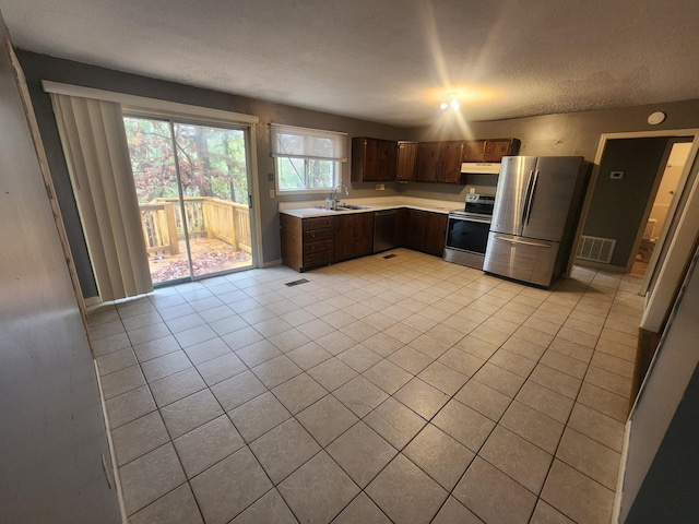 906 Edwards St, Madisonville, KY 42431 - kitchen with light countertops, dark brown cabinets, appliances with stainless steel finishes, under cabinet range hood, and a sink