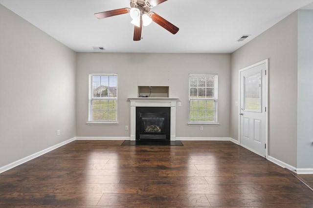 2033 Hidden Cove Rd, Mount Juliet, TN 37122 - unfurnished living room featuring a fireplace with flush hearth, baseboards, visible vents, a ceiling fan, and wood finished floors