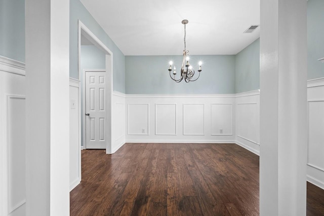 2033 Hidden Cove Rd, Mount Juliet, TN 37122 - unfurnished dining area featuring a wainscoted wall, a decorative wall, visible vents, dark wood-style floors, and an inviting chandelier