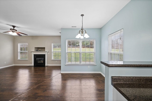 2033 Hidden Cove Rd, Mount Juliet, TN 37122 - unfurnished living room featuring ceiling fan with notable chandelier, a fireplace with flush hearth, dark wood-style floors, and a healthy amount of sunlight