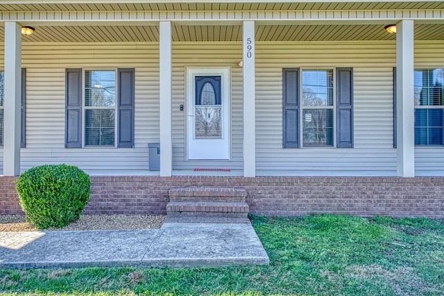 view of exterior entry with a porch