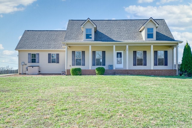 cape cod home featuring a front yard, covered porch, and roof with shingles