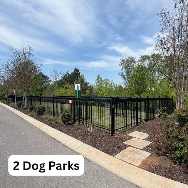 view of gate with a lawn and fence