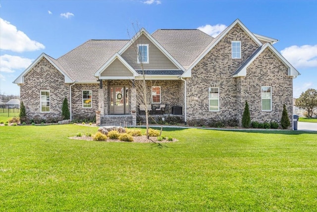 craftsman-style home featuring brick siding, a porch, and a front lawn