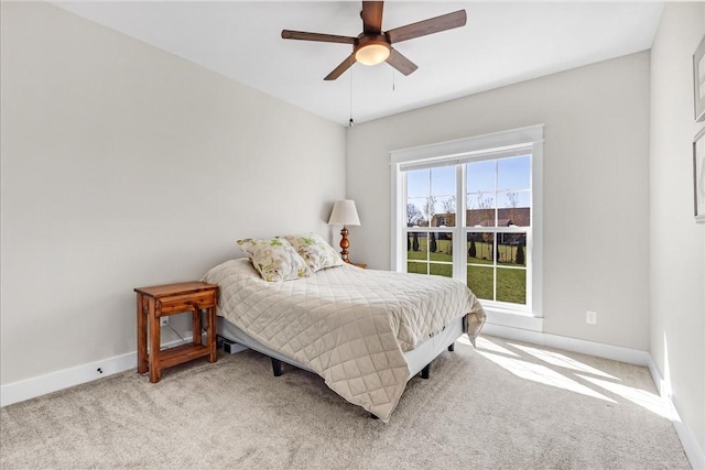 carpeted bedroom with baseboards and ceiling fan