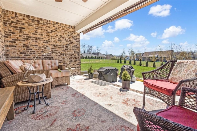 view of patio / terrace featuring an outdoor hangout area, area for grilling, and a ceiling fan