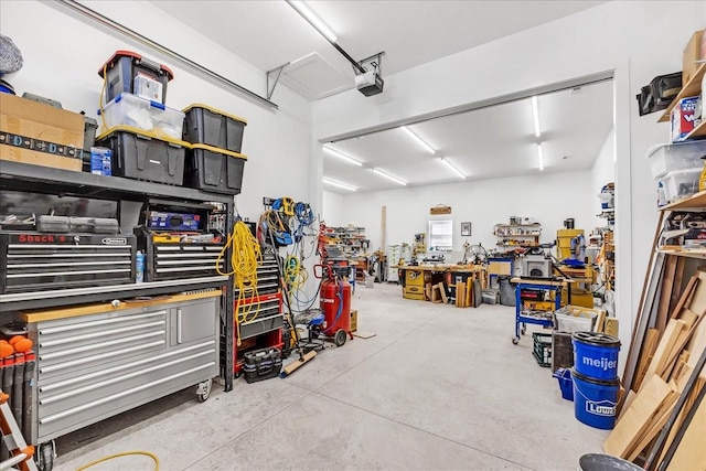garage with a garage door opener and a workshop area