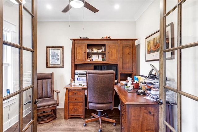 home office featuring wood finished floors, ceiling fan, ornamental molding, and baseboards