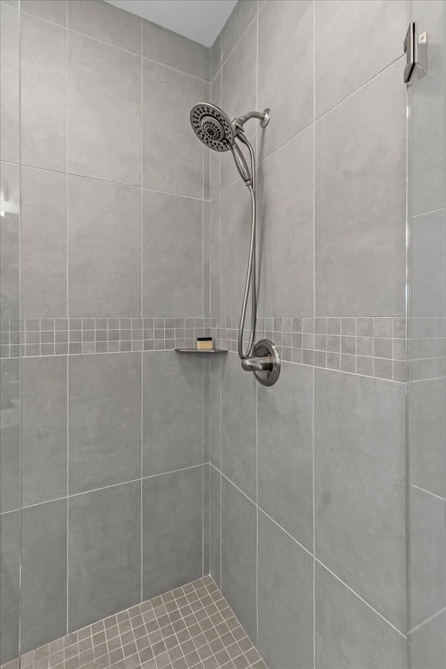 bathroom with a tile shower