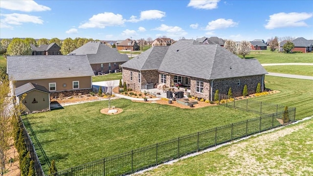 back of house with an outdoor structure, a patio, a shed, an outdoor fire pit, and a fenced backyard