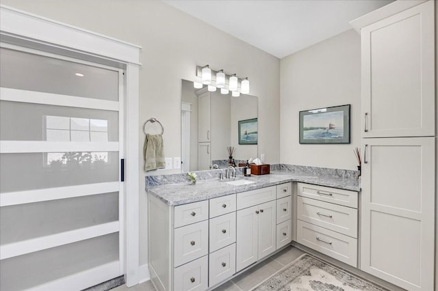 bathroom with tile patterned floors and vanity