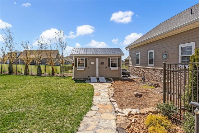 back of property with a lawn, an outdoor structure, a fenced backyard, and a storage shed