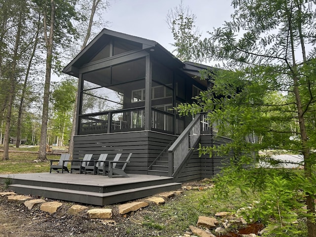 24 Acorn Cv, Tracy City, TN 37387 - rear view of house featuring a wooden deck, a sunroom, and stairway