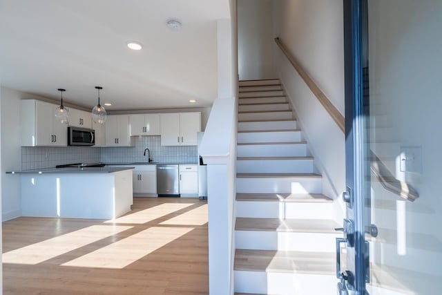stairway featuring recessed lighting and wood finished floors