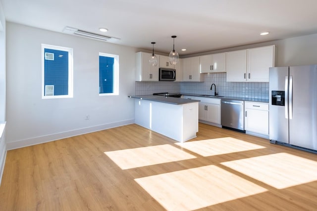 kitchen with white cabinetry, appliances with stainless steel finishes, and a sink