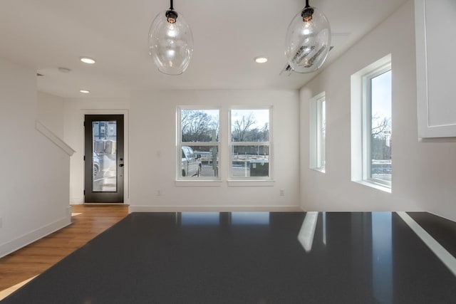 entryway featuring light wood-style floors, baseboards, and recessed lighting