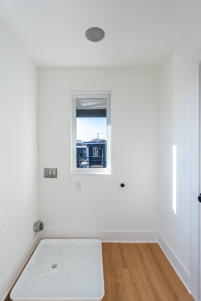laundry room featuring washer hookup, laundry area, electric dryer hookup, baseboards, and light wood-style flooring