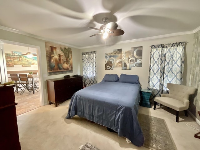 bedroom featuring crown molding, ceiling fan, and light colored carpet