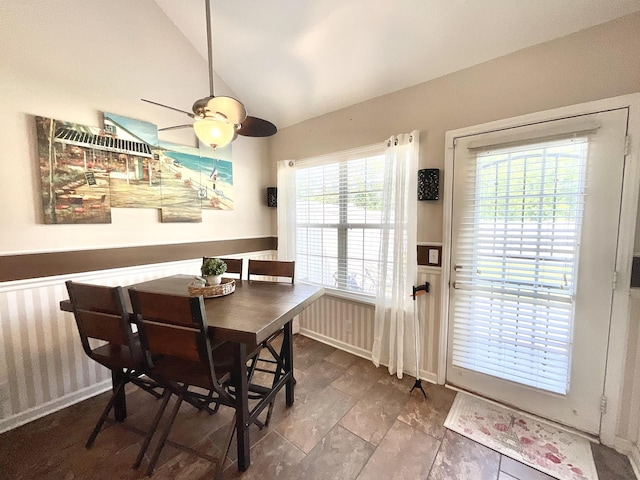 dining room featuring a ceiling fan and vaulted ceiling