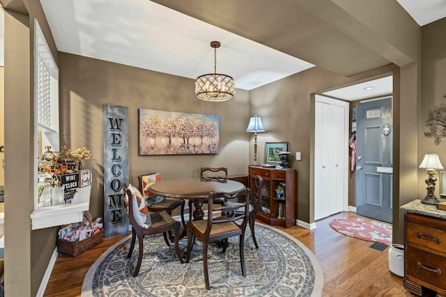 5025 Hillsboro Pike Unit 20E, Nashville, TN 37215 - dining space featuring baseboards, light wood-style flooring, and a chandelier