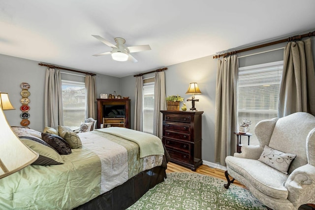 5025 Hillsboro Pike Unit 20E, Nashville, TN 37215 - bedroom with baseboards, light wood-style floors, and a ceiling fan