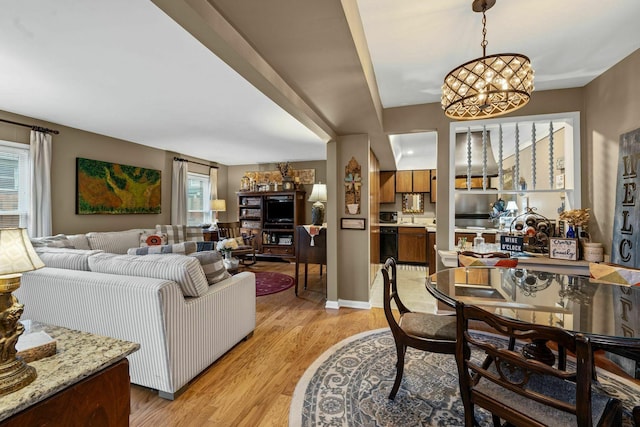 5025 Hillsboro Pike Unit 20E, Nashville, TN 37215 - dining room with a healthy amount of sunlight, a notable chandelier, and light wood finished floors