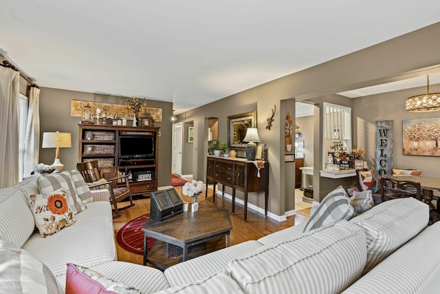 5025 Hillsboro Pike Unit 20E, Nashville, TN 37215 - living area featuring baseboards, wood finished floors, and a notable chandelier